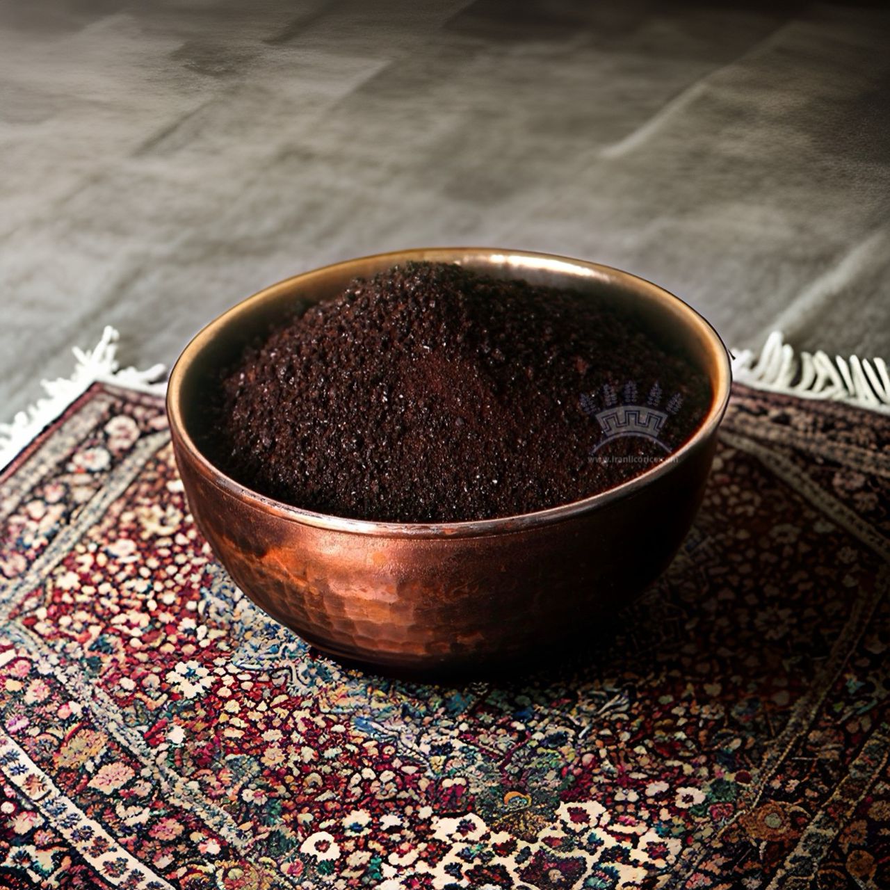 Licorice extract granules in a copper bowl on a Persian rug by Sepidan Osareh Jonoob.